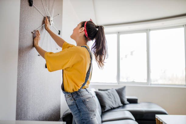 istock Young woman decorating her home 1320544464