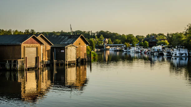 Boathouses in Plau am See Mecklenburg Lake District: Summer evening atmosphere in Plau am See with typical boathouses on Lake Plau. muritz national park photos stock pictures, royalty-free photos & images