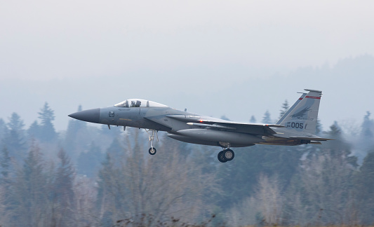 Portland, Oregon, USA - January 29, 2021: A F-15 of the 142nd Fighter Wing comes in for landing at the Air National Guard base located at Portland International Airport. The 142nd Fighter Wing, also known as the Redhawks, patrol the airspace from the California border north to the Canadian border.