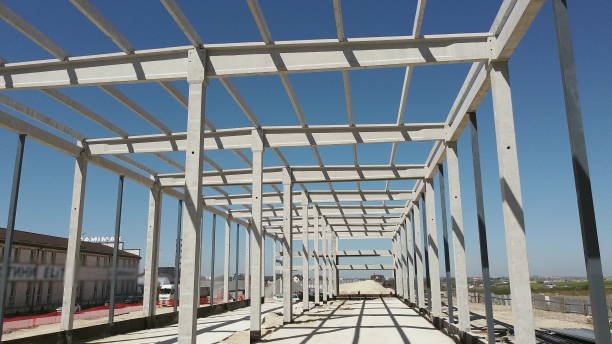 istock Reinforced Concrete Frame Of An Industrial Building. Camera Flight On A Construction Site. Beams With Steel Reinforcement From Above. Concrete Building Construction Industrial Site 1320547191