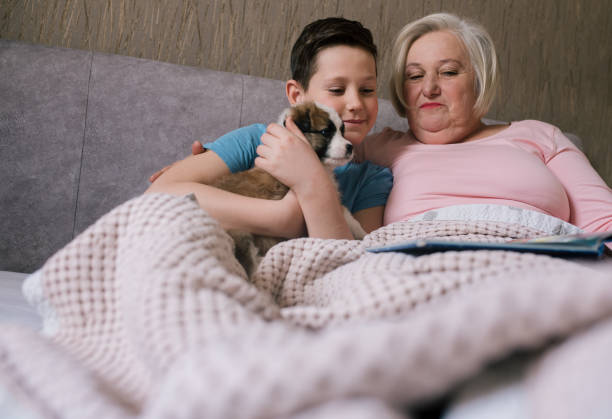 istock Granny relaxing on bed with her grandson. 1320550445