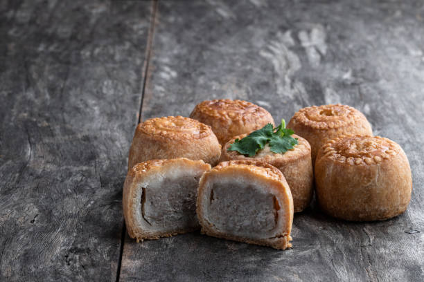 Mini Melton Mowbray pork pies on rustic wooden table