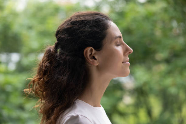 istock Peaceful happy young woman meditating with closed eyes. 1320550924