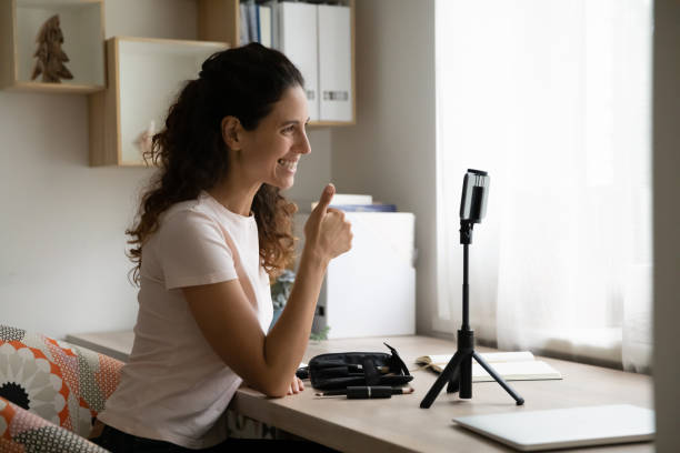 istock Smiling hispanic female blogger enjoying vlogging activity. 1320551774