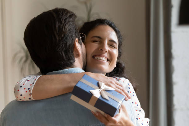 istock Cheerful young woman cuddling man, feeling thankful. 1320551790