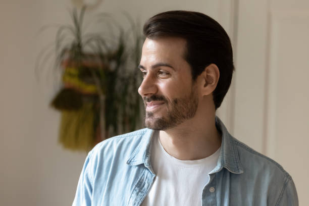 istock Dreamy young happy man looking in distance. 1320551791