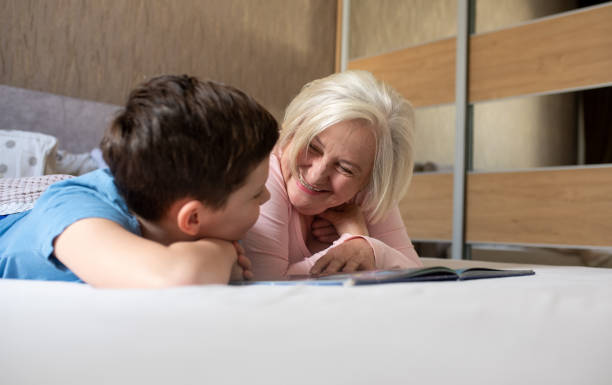 istock Granny is reading a story to her grandson. 1320553481