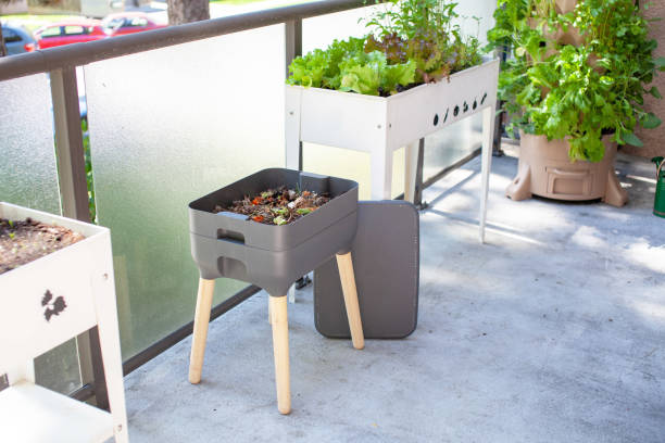 A vermicomposting system (worm composter) sits on an apartment balcony stock photo