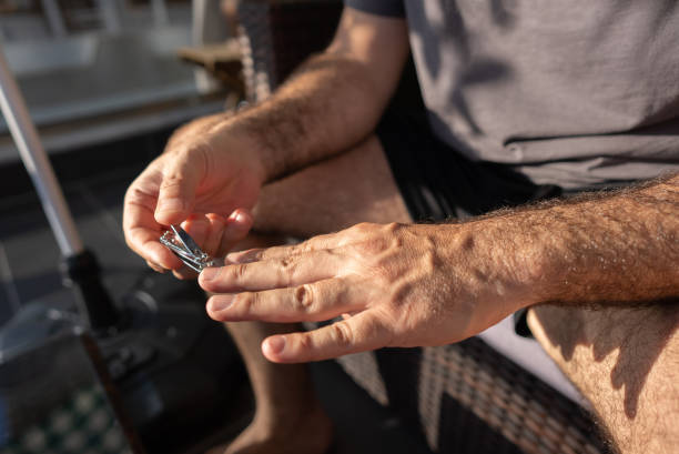 istock Man is cutting his nails by Clippers. Close-up hands 1320561503