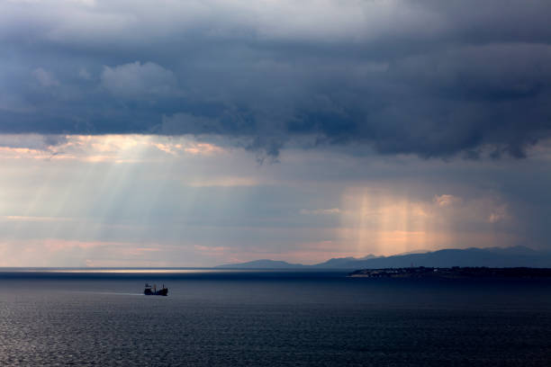 istock Industrial Ship Silhouettes with Sunbeams 1320564241