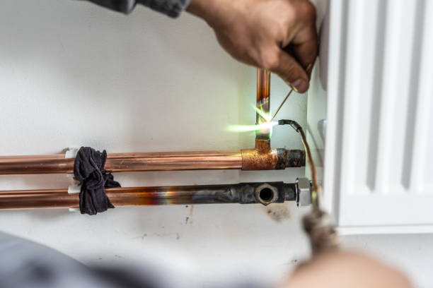 istock Close up on hands Unknown industrial worker plumber with central heating copper pipes welding using gas torch or blowtorch on the wall in house building or apartment - real people at work copy space 1320565926