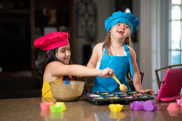 istock Two friends following a cupcake recipe online 1320567772