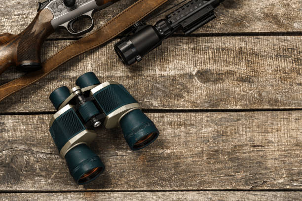 istock Hunting equipment binoculars on wooden background close up 1320572078