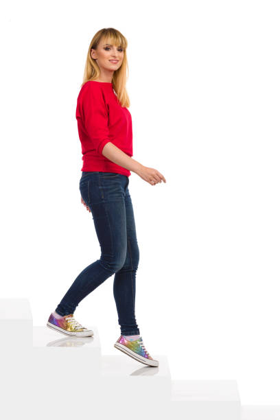 istock Happy Young Woman Is Walking Down The Stairs 1320577470