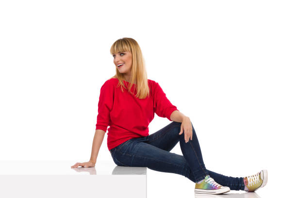 istock Happy Young Woman Is Sitting On A Step And Looking Back Over The Shoulder 1320577471