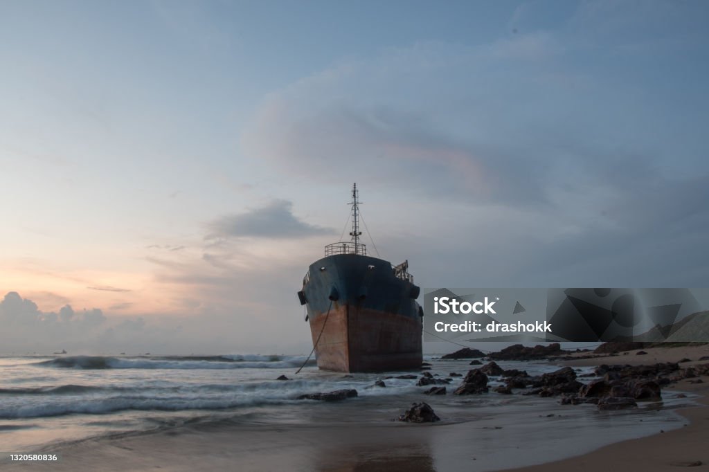 Beached ship at dawn A shipwreck at dawn in Visakhapatnam, India. Visakhapatnam Stock Photo