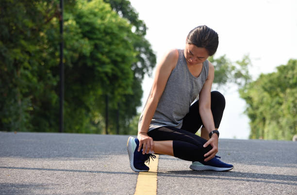 istock Female athlete with joint or muscle soreness and problem feeling ache in her lower body. 1320584030