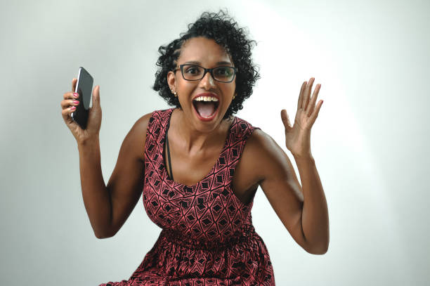 istock Happy black young woman on cheerful pose against white background 1320585789