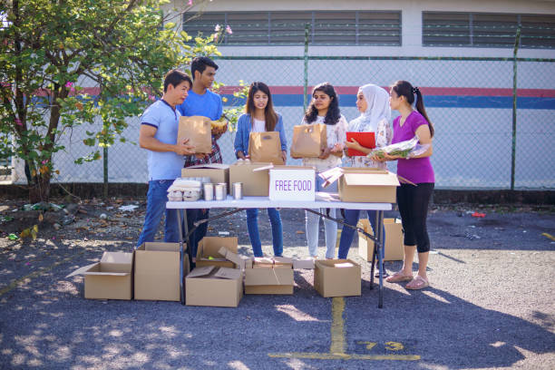 istock Diverse group volunteers for local food drive. 1320587312