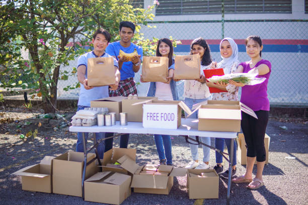 istock Happy volunteers holding donation bags. 1320587344
