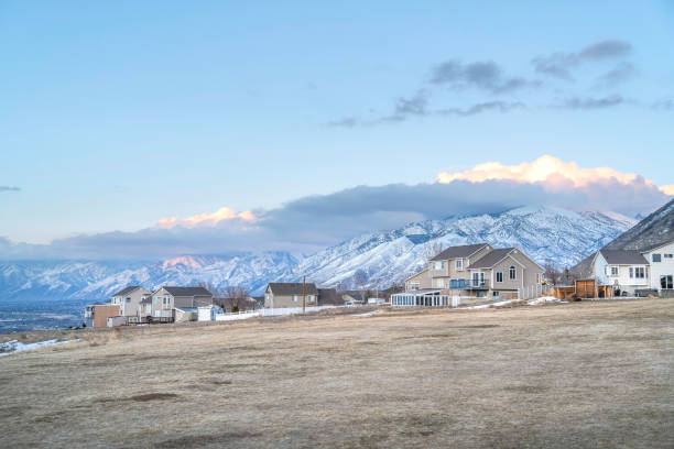 istock Homes overlooking snowy mountain peak towering over the valley on a cloudy day 1320589364