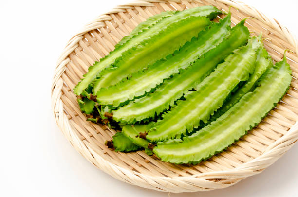 istock Fresh Winged beans on a bamboo sieve on a white background 1320591042