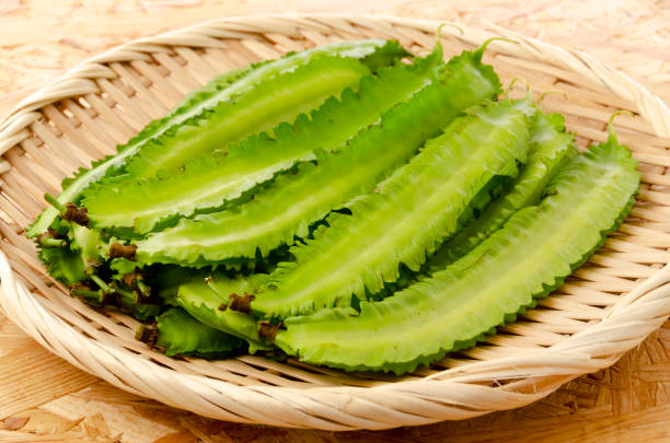 istock Fresh Winged beans on a bamboo sieve on a plywood Board background 1320591216