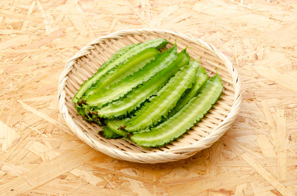 istock Fresh Winged beans on a bamboo sieve on a plywood Board background 1320591331