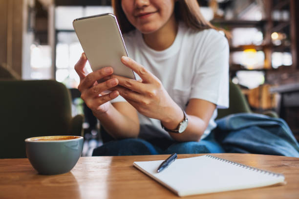 istock a beautiful young asian woman holding and using mobile phone 1320593727