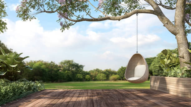 Old wooden terrace with wicker swing 3d render Old wooden terrace with wicker swing hang on the tree with blurry nature background 3d render. patio stock pictures, royalty-free photos & images