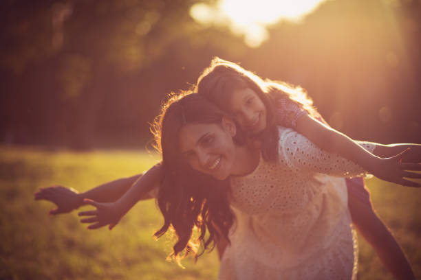 istock Mother and daughter dancing together in nature. 1320602001