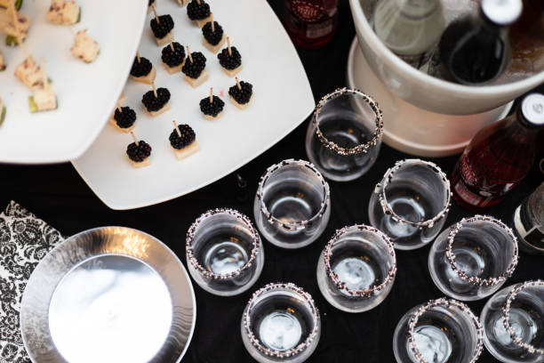 hors d'oeuvres of black and white colors on platters at a fancy dinner party - hors imagens e fotografias de stock