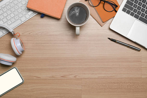 istock Hipster workplace with laptop computer, notebook, headphone and coffee cup on wooden table. 1320602269