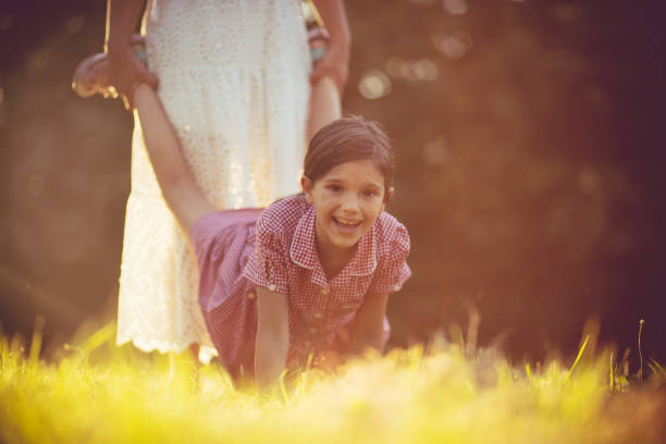 istock Mother and daughter dancing together in nature. 1320604138