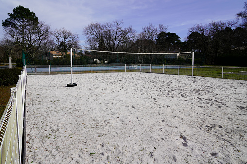 beach volleyball court with sand on the ground and net in city playground