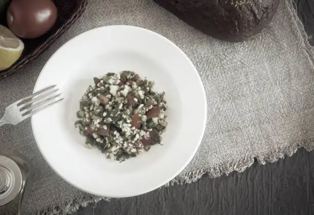 Photo of Arabic cuisine: popular vegetable salad with bulgur cereals.