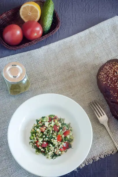 Photo of Arabic cuisine: popular vegetable salad with bulgur cereals.