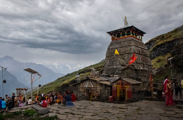 June 16 2019 Tungnath temple, Chopta, Uttrakhand,India. Pilgrims visiting tungnath Shiva temple. Tungnath is one of the highest Shiva temples in the world and is the highest of the five Panch Kedar temples located in Rudraprayag district. June 16 2019 Tungnath temple, Chopta, Uttrakhand,India. Pilgrims visiting tungnath Shiva temple. Tungnath is one of the highest Shiva temples in the world and is the highest of the five Panch Kedar temples located in Rudraprayag district. The temple is covered with dramatic clouds in the sky. high temple stock pictures, royalty-free photos & images