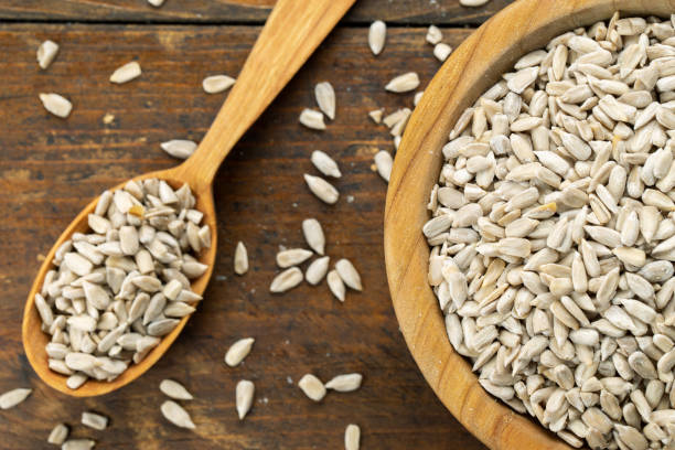 istock Sunflower seeds in a wooden spoon 1320609987