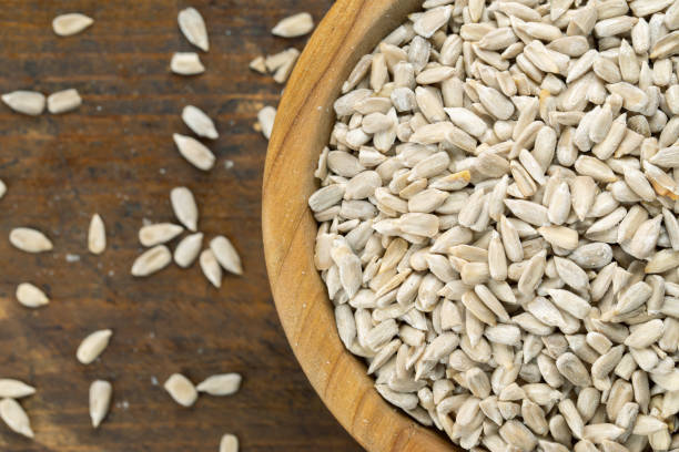 istock sunflower seeds in wooden bowl. 1320609992