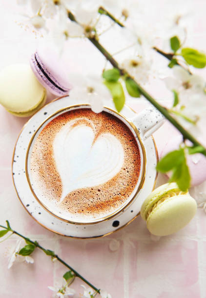 istock Coffee with a heart-shaped pattern and sweet macaroons desserts 1320613661