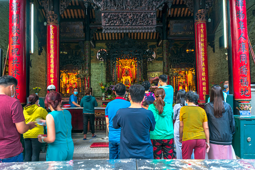 Ho Chi Minh City, Vietnam - February 11th, 2021: Spring lively atmosphere at temple to pray with pilgrims for peace as this incense ethnic traditions New Year's Day in Ho Chi Minh City, Vietnam