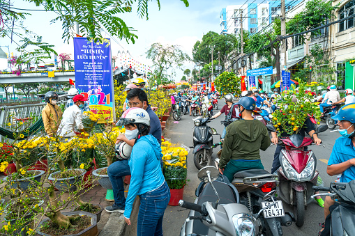 Ho Chi Minh City, Vietnam - February 9, 2021: Bustle of buying flowers at flower market, locals buy flowers for decoration purpose the house on Lunar New Year in Ho Chi Minh City, Vietnam.