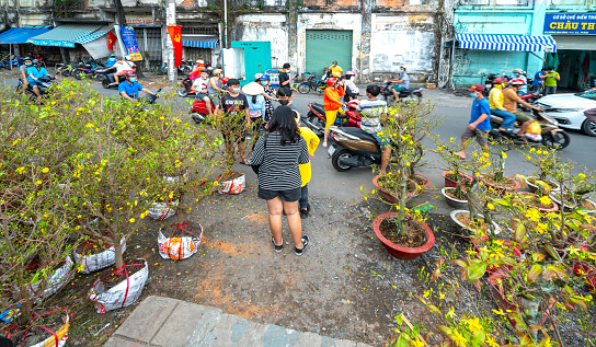 Ho Chi Minh City, Vietnam - February 9, 2021: Bustle of buying flowers at flower market, locals buy flowers for decoration purpose the house on Lunar New Year in Ho Chi Minh City, Vietnam.