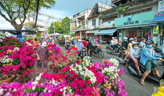 Ho Chi Minh City, Vietnam - February 9, 2021: Bustle of buying flowers at flower market, locals buy flowers for decoration purpose the house on Lunar New Year in Ho Chi Minh City, Vietnam.
