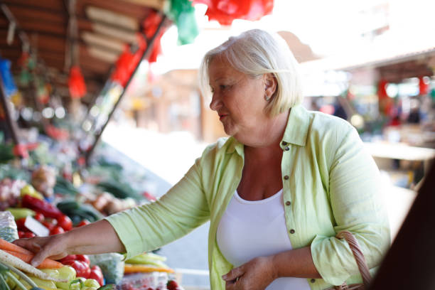 istock Blond senior woman picking vegetables. 1320621742