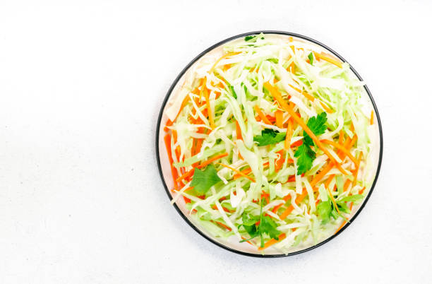 istock Salad coleslaw with cabbage, carrot on white kitchen table background. Top view, copy space 1320622531