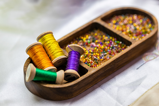 Colorful threads and beads in a wooden box