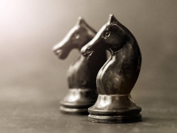 istock Two pieces horses chess on piano keys 1320622937