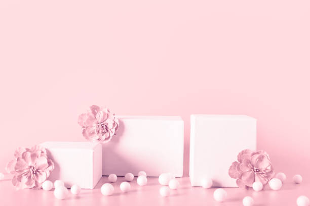 istock Pink toned empty stands decorated  flowers on color background. 1320624153